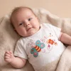 White butterfly print t-shirt worn by a baby, size 0–3 months