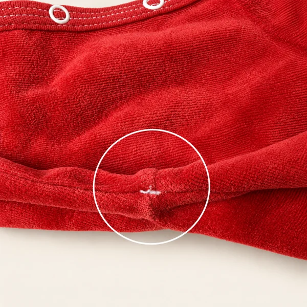 Red velour sweatshirt, close-up of a small stitch mark under the arm